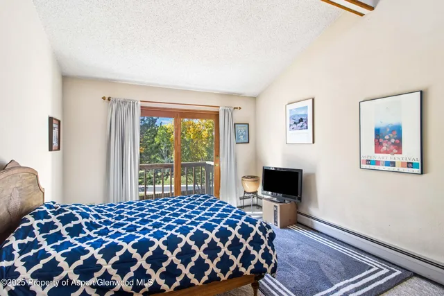 a bedroom with a bed and dresser