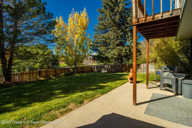 a view of backyard with swimming pool and outdoor seating