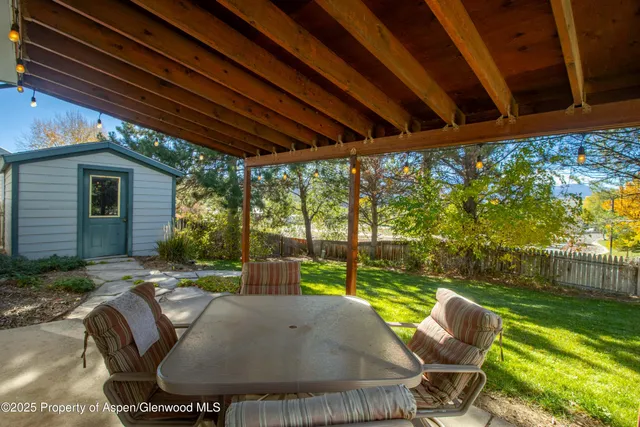 an aerial view of a house with a yard and garden