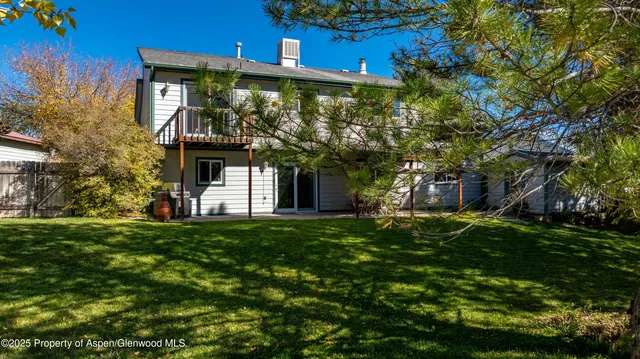 an aerial view of house with yard and swimming pool