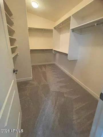 a view of walk in closet with empty racks