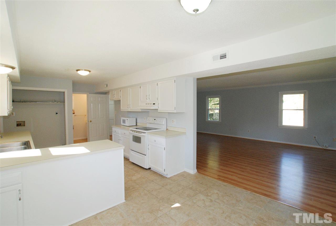 3617 Wickersham Way Raleigh, NC 27604 - Photo 8 of 25 a room with a stove a sink and a refrigerator