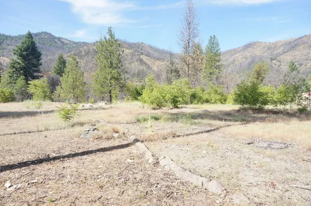 a view of dirt yard with mountain view