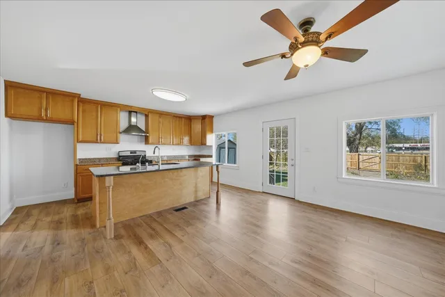 a kitchen with a refrigerator cabinets and wooden floor