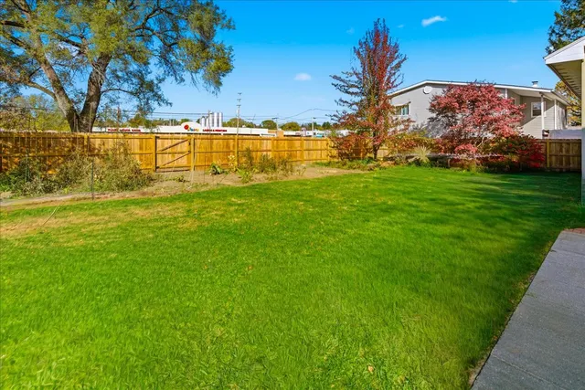 a view of a large yard with an ocean view