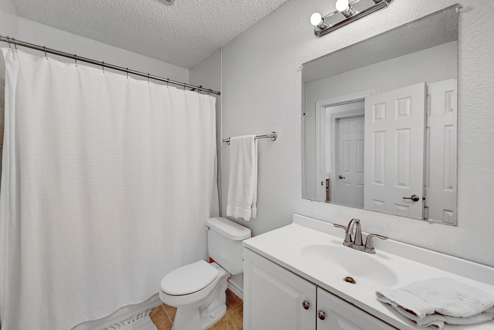 7635 Guadalupe Street, Unit 1002 Austin, TX 78752 - Photo 18 of 27 a bathroom with a sink toilet and mirror