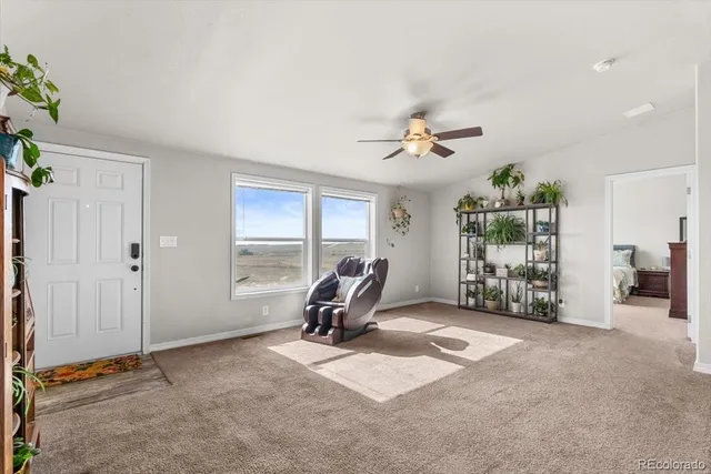 a view of a livingroom with furniture and a ceiling fan