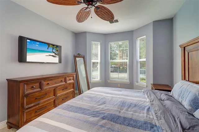 a bedroom with a bed and a chandelier