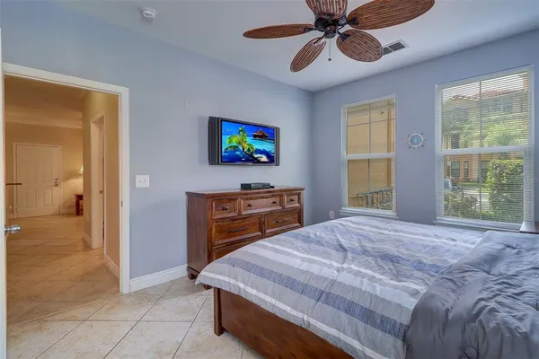 a bedroom with a bed and a flat screen tv