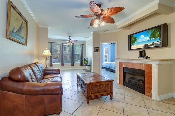 a living room with furniture a flat screen tv and a fireplace