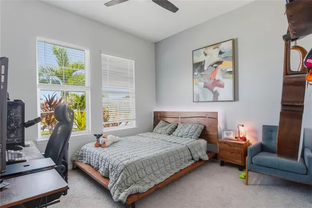 a bedroom with a bed a couch and a window