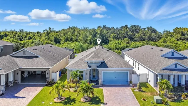 an aerial view of a house with swimming pool garden and patio