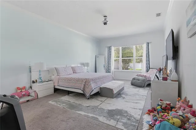 a bedroom with furniture and a flat screen tv