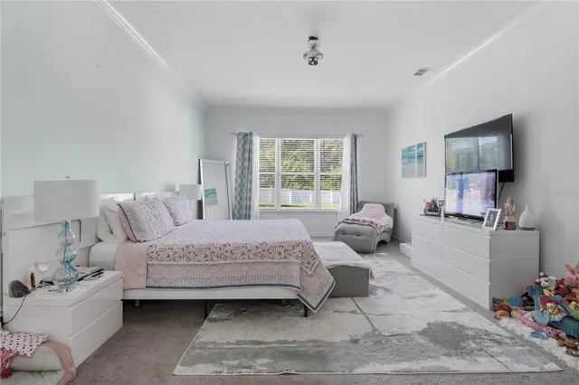 a bedroom with a bed wooden floor and window