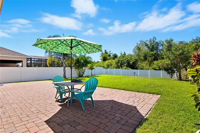 a patio with a table and chairs