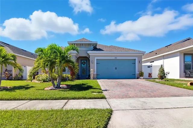 a front view of a house with a yard and trees
