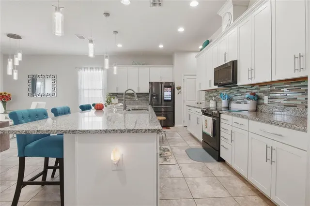 a kitchen with stainless steel appliances granite countertop a sink and cabinets