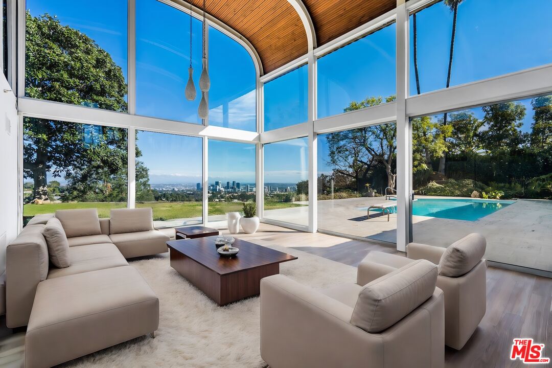 11271 Chalon Road Los Angeles, CA 90049 - Photo 1 of 35 a living room with patio furniture and a garden
