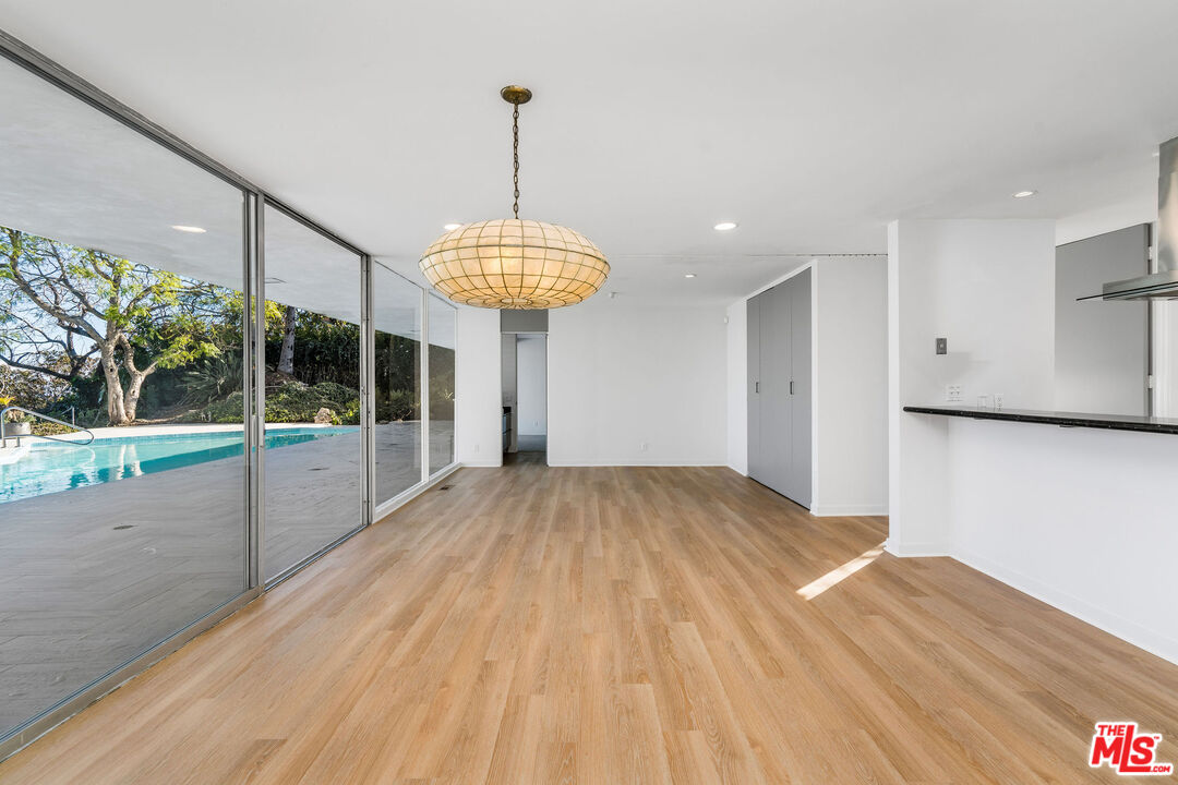 11271 Chalon Road Los Angeles, CA 90049 - Photo 11 of 35 a view of empty room with wooden floor and outdoor shower