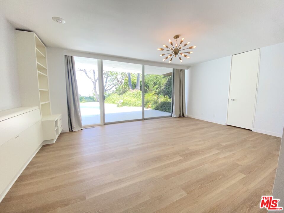 11271 Chalon Road Los Angeles, CA 90049 - Photo 17 of 35 a view of an empty room with a window