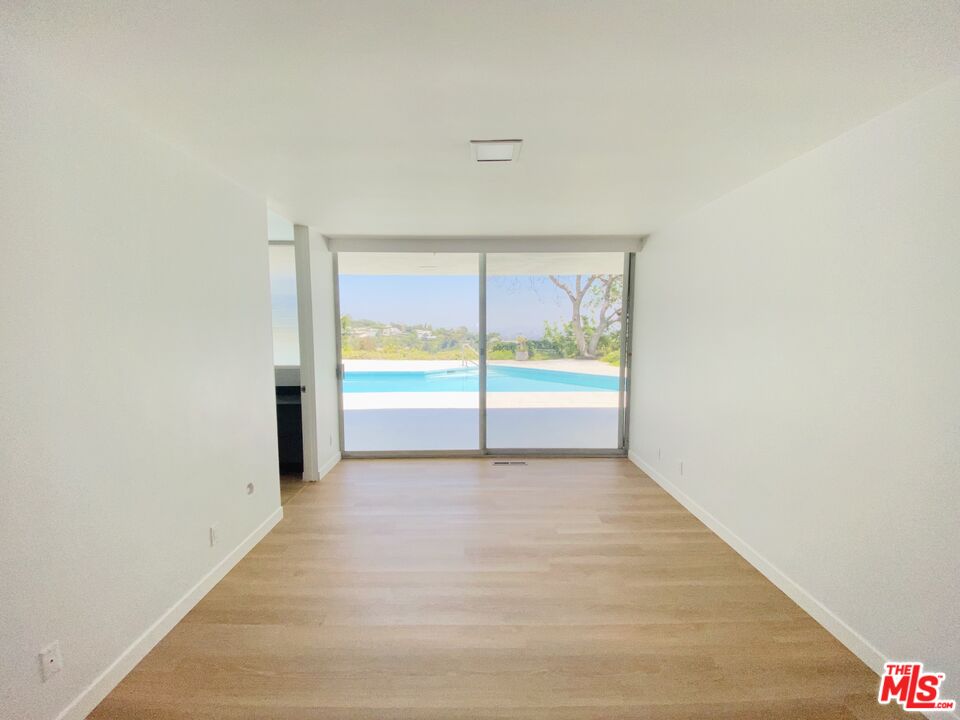 11271 Chalon Road Los Angeles, CA 90049 - Photo 21 of 35 a view of an empty room with a window