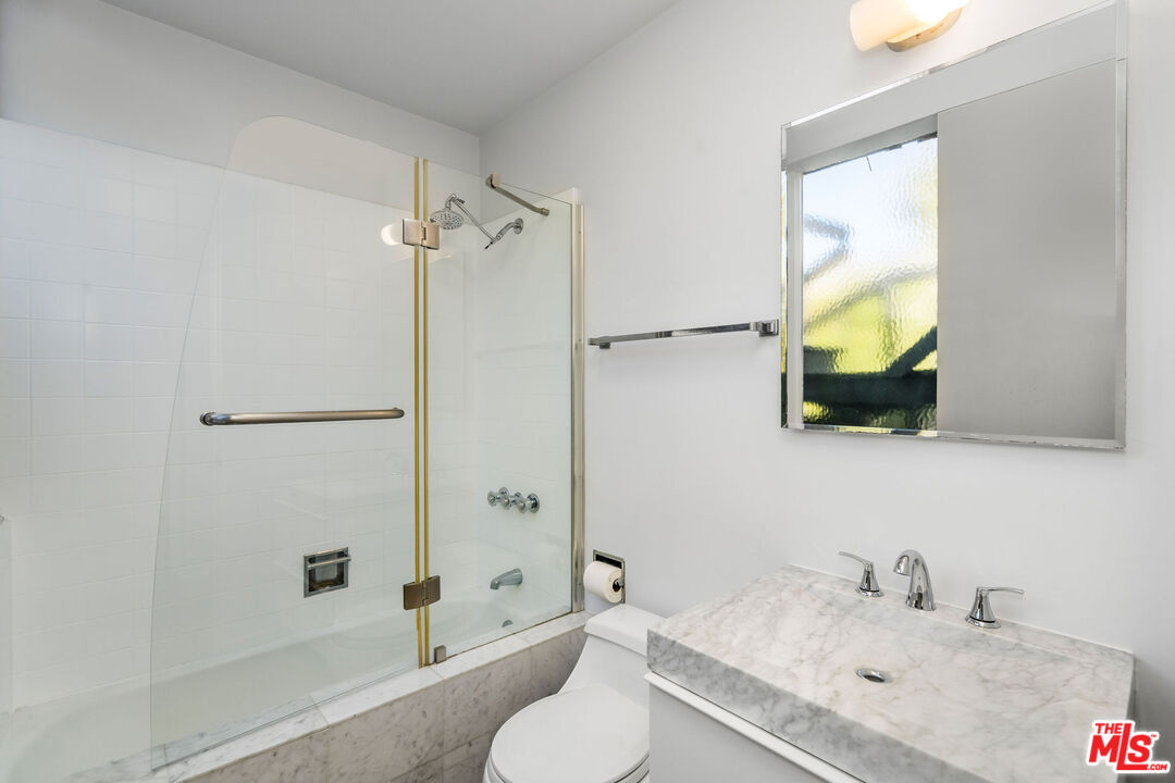 11271 Chalon Road Los Angeles, CA 90049 - Photo 24 of 35 a bathroom with a sink and a mirror