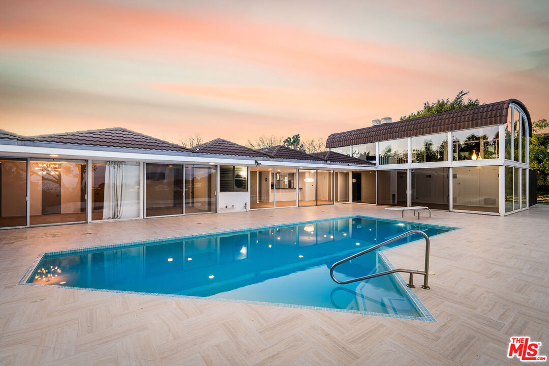 11271 Chalon Road Los Angeles, CA 90049 - Photo 31 of 35 a view of house with a swimming pool