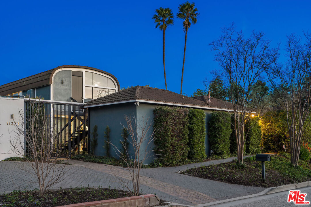 11271 Chalon Road Los Angeles, CA 90049 - Photo 33 of 35 a front view of a house with garden