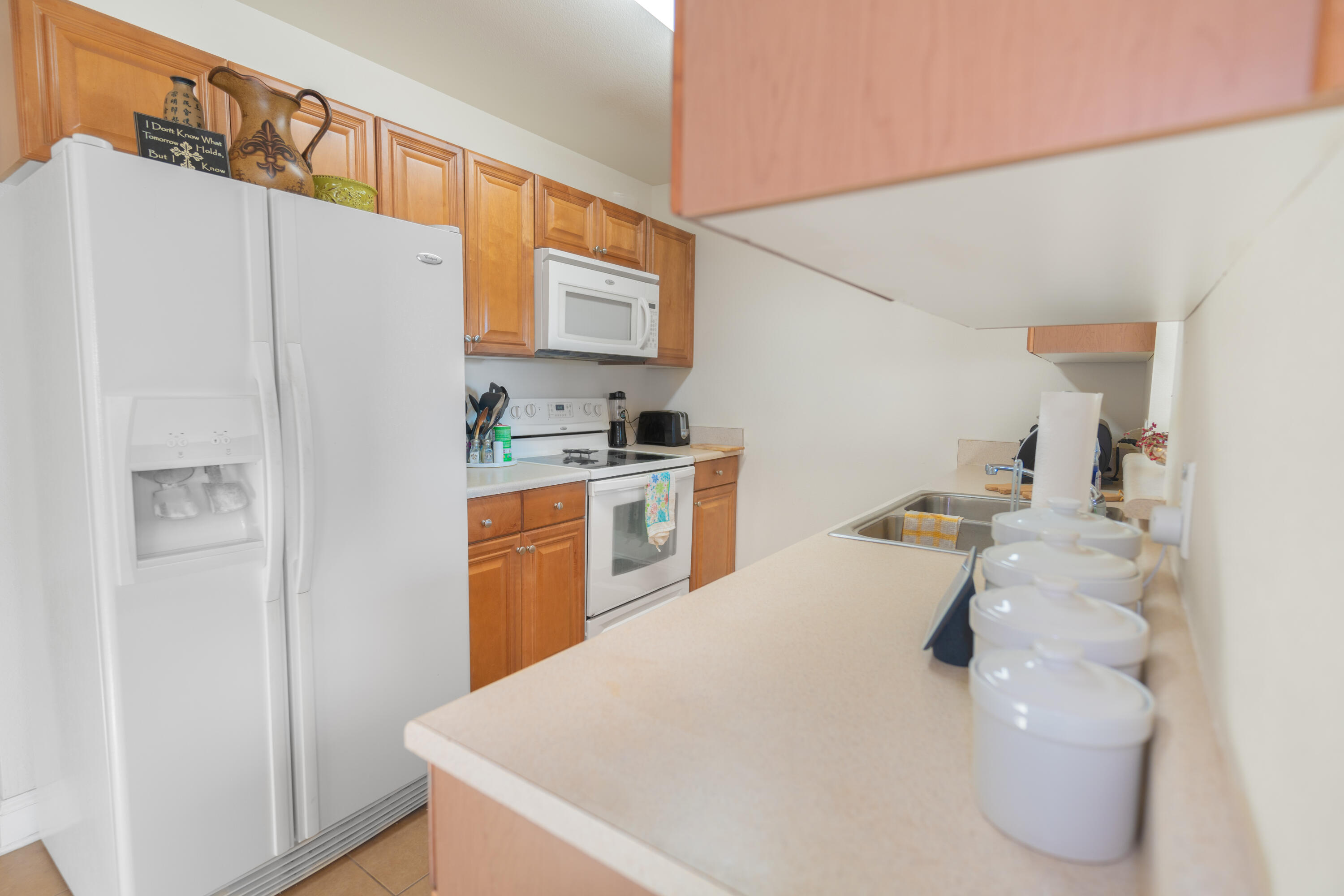 583 Wingspan Way Crestview, FL 32536 - Photo 3 of 11 a kitchen with stainless steel appliances a refrigerator a sink a stove and white cabinets
