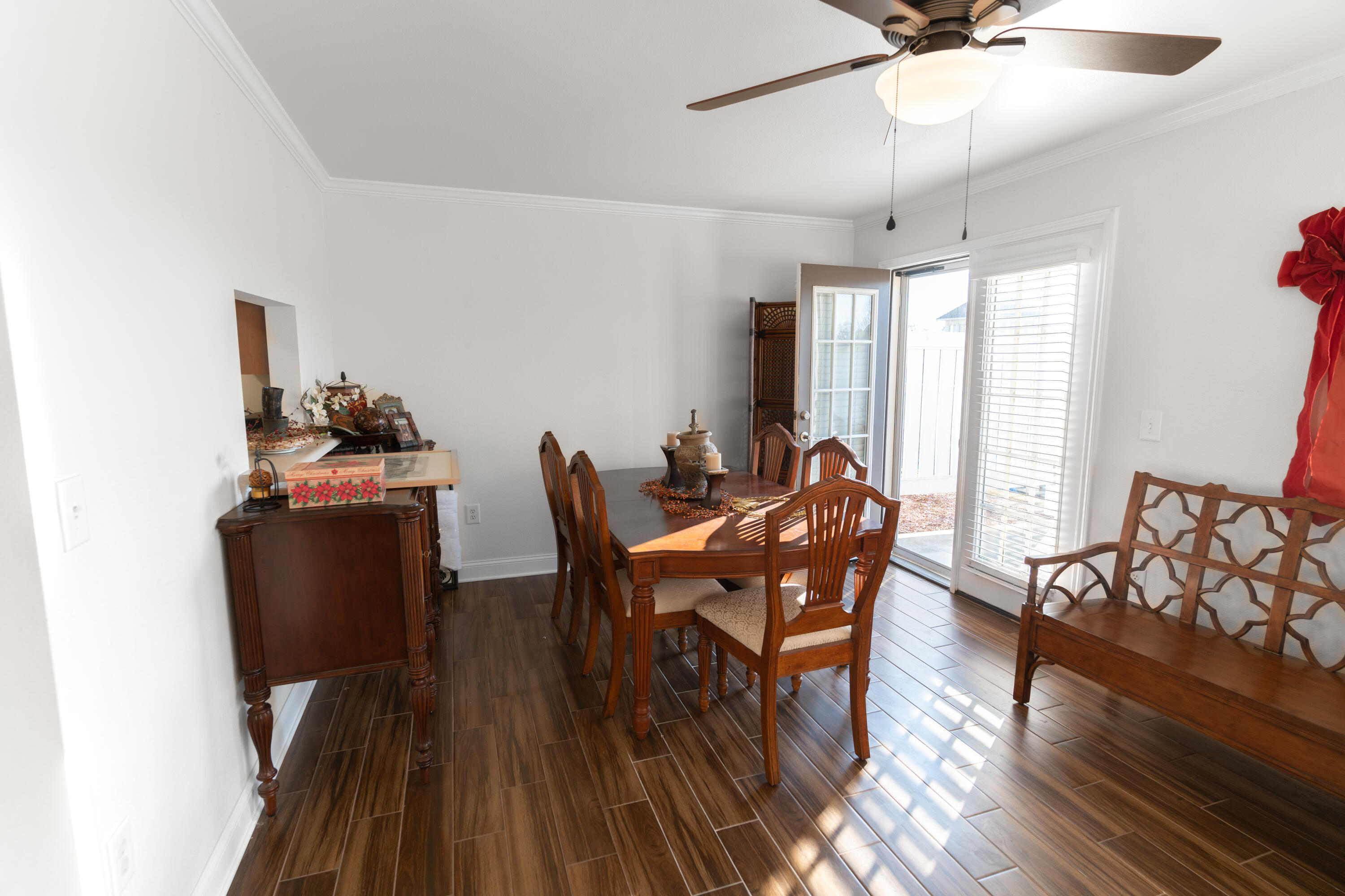 583 Wingspan Way Crestview, FL 32536 - Photo 6 of 11 a dining room with furniture a chandelier and wooden floor