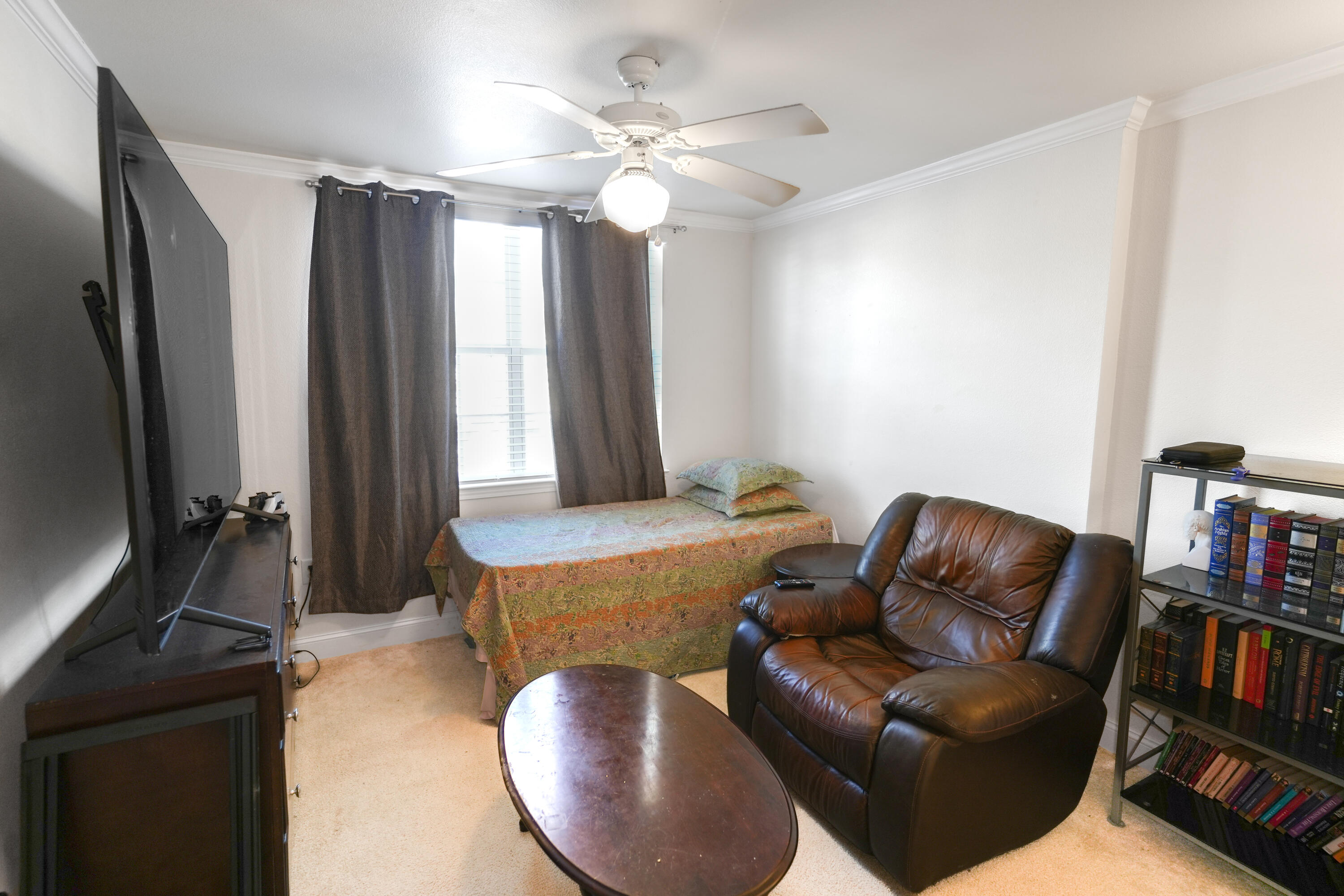 583 Wingspan Way Crestview, FL 32536 - Photo 7 of 11 a living room with furniture a bookshelf and a flat screen tv