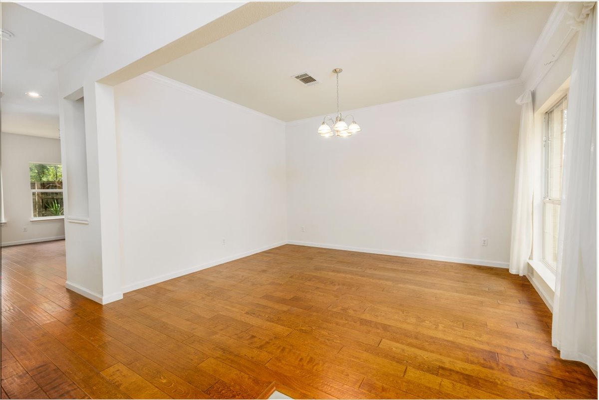 7136 Ridge Oak Road Austin, TX 78749 - Photo 7 of 28 Hardwood flooring extends throughout this versatile, well-lit interior space.