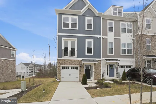 a front view of a residential apartment building with a yard