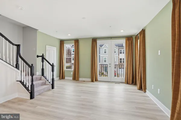 a view of an entryway with wooden floor and stairs