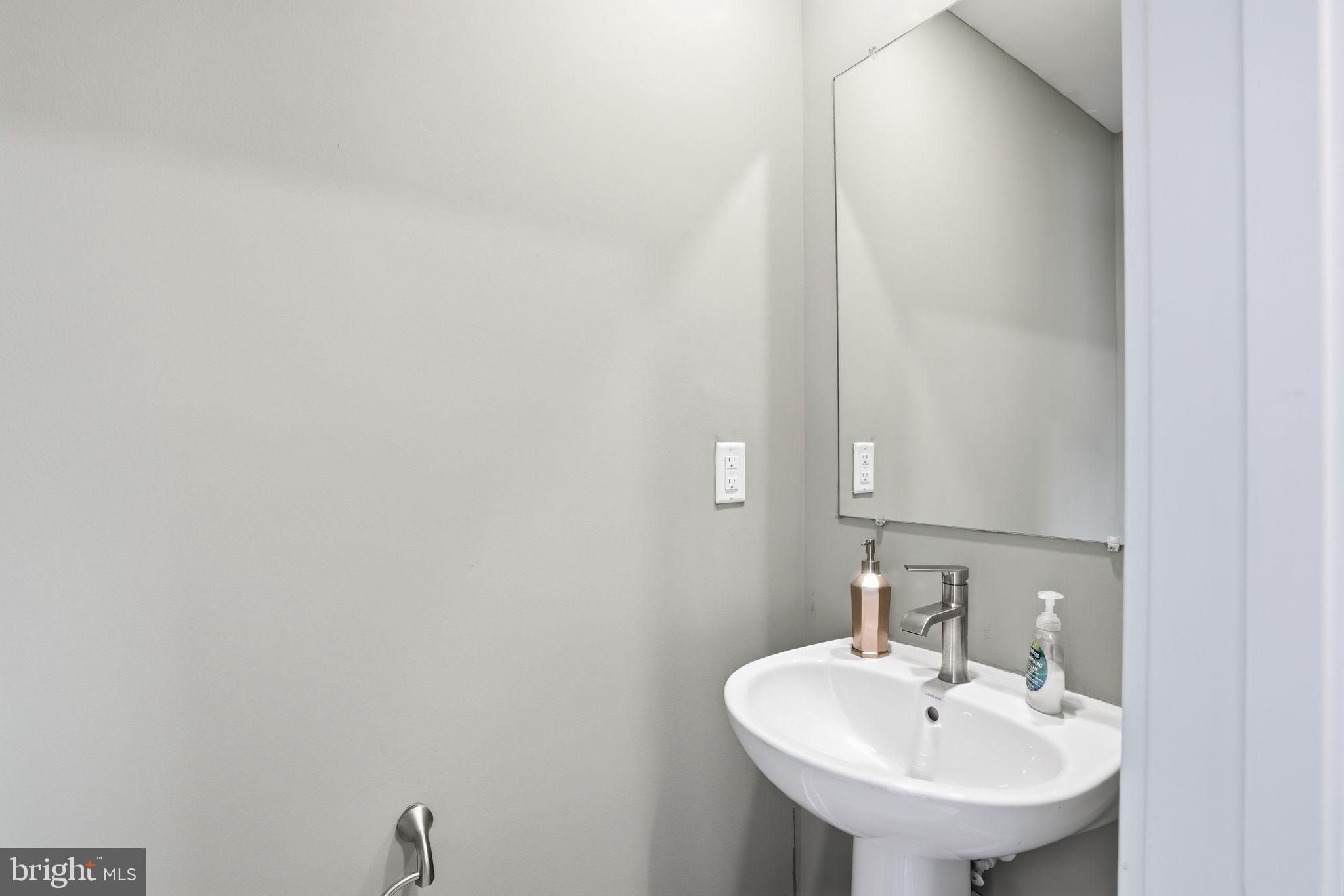 1810 Betterton Road Essex, MD 21221 - Photo 17 of 34 a bathroom with a sink and a mirror