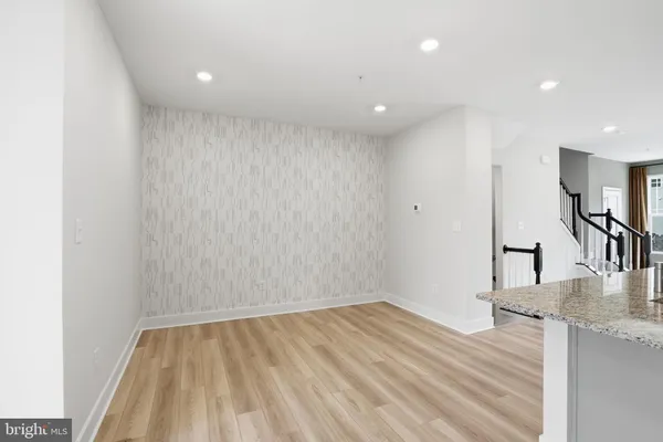 a view of a room with wooden floor and a sink
