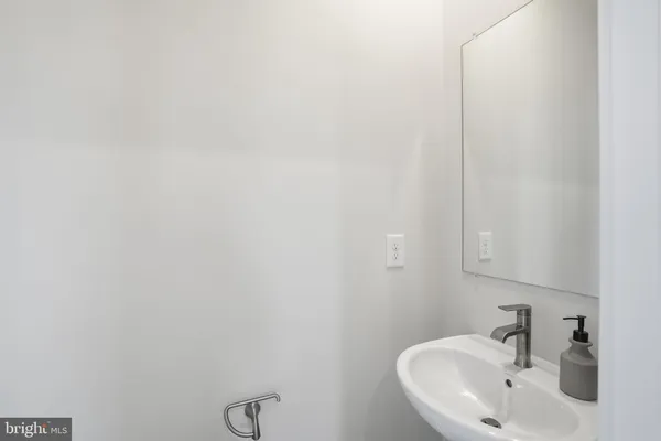 a bathroom with a sink and mirror