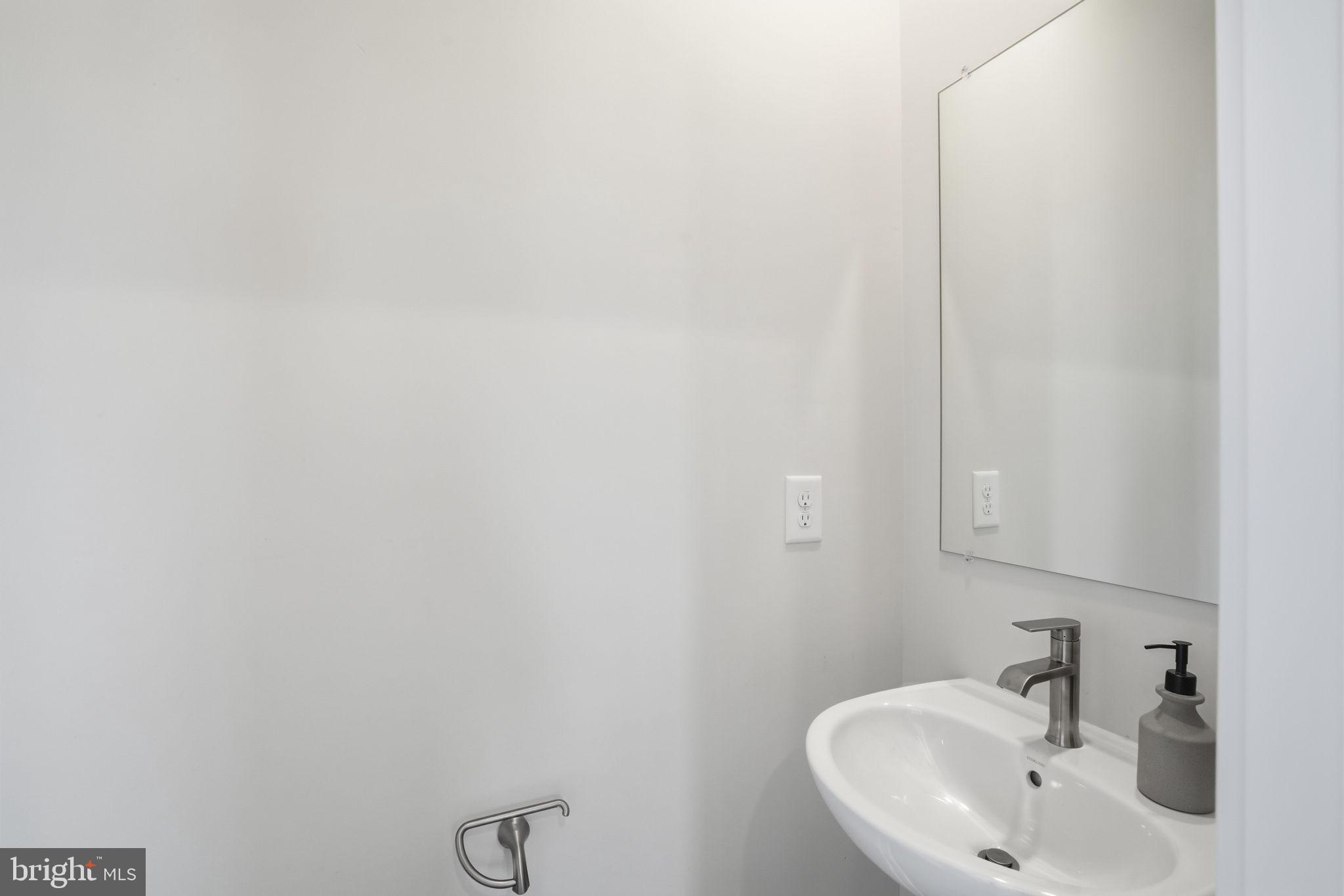 1810 Betterton Road Essex, MD 21221 - Photo 22 of 34 a bathroom with a sink and mirror