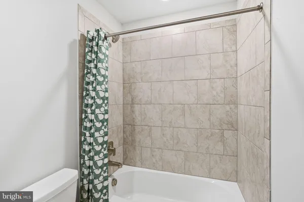 a bathroom with a bathtub and shower
