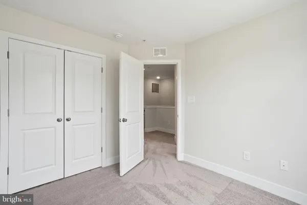 a view of an empty room and closet
