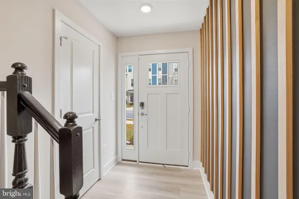 a view of a hallway with closet and front door
