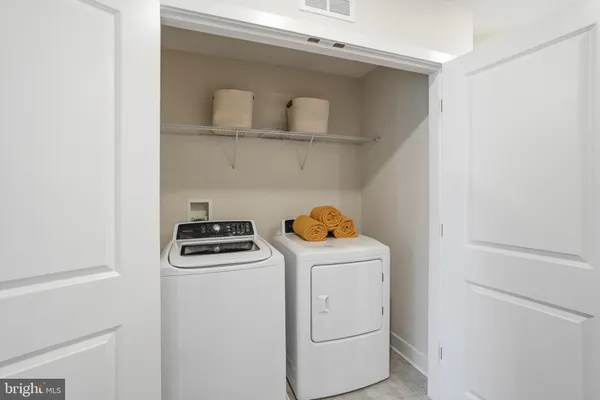 a view of storage and utility room with washer and dryer