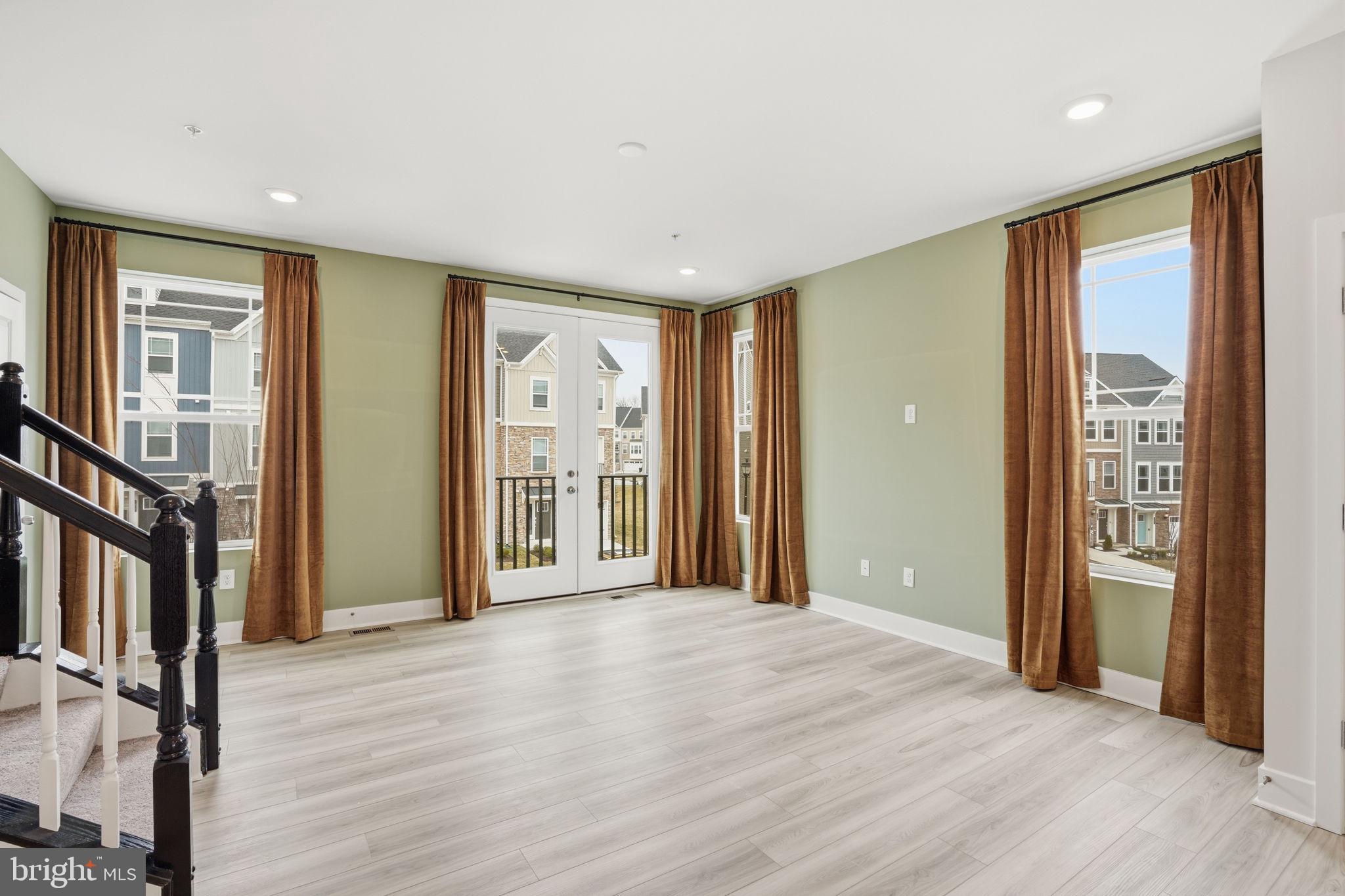 1810 Betterton Road Essex, MD 21221 - Photo 9 of 34 a view of a big room with wooden floor and windows