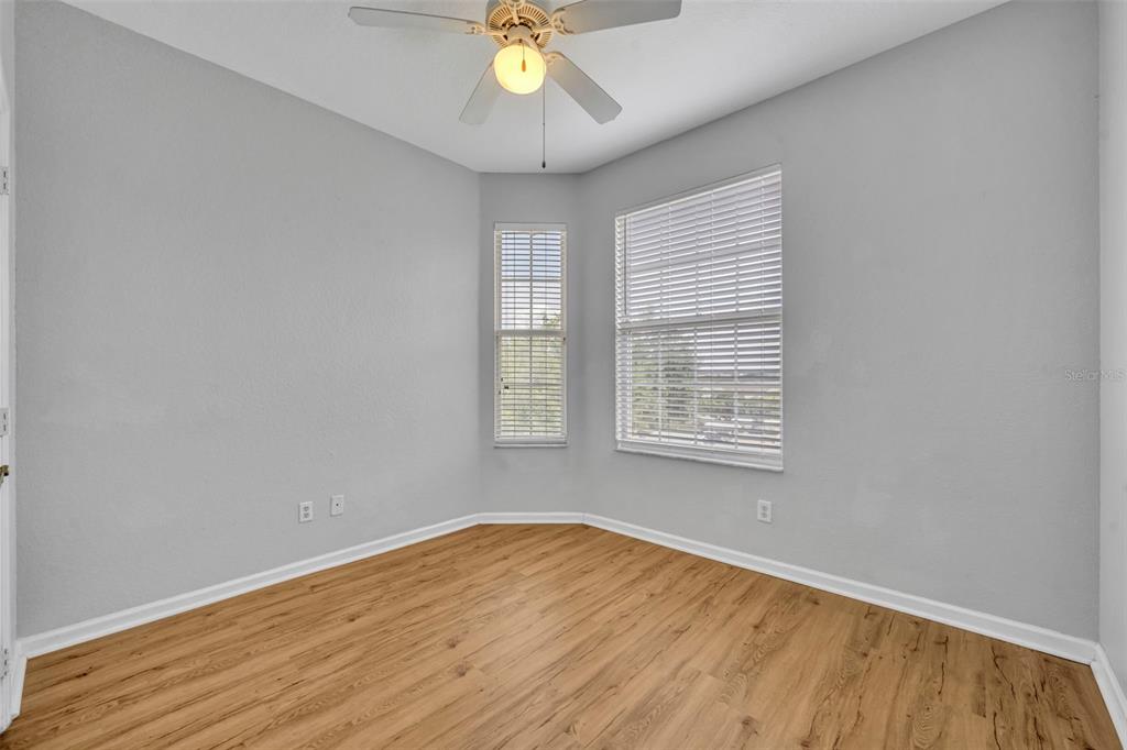 582 Brantley Terrace Way, Unit 304 Altamonte Springs, FL 32714 - Photo 25 of 30 an empty room with wooden floor and windows