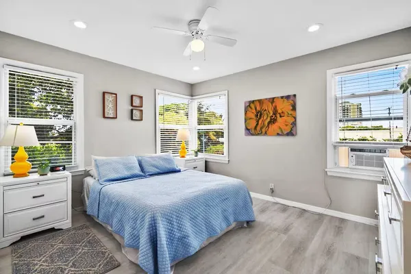 a bedroom with a bed and wooden floor