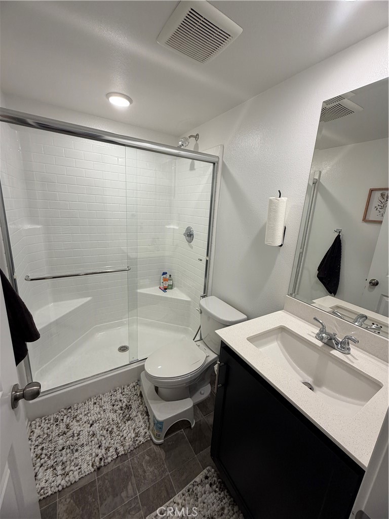 1316 Goldenbrush Way Banning, CA 92220 - Photo 16 of 17 a bathroom with a sink a toilet a mirror and shower