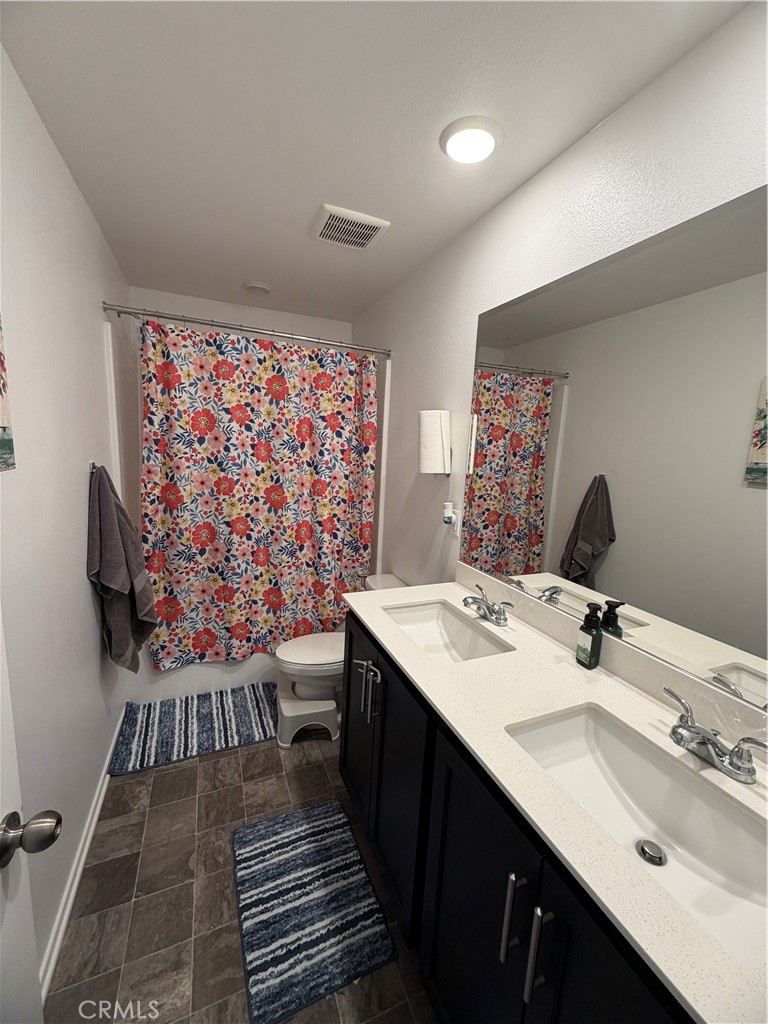 1316 Goldenbrush Way Banning, CA 92220 - Photo 3 of 17 a bathroom with a sink and a mirror