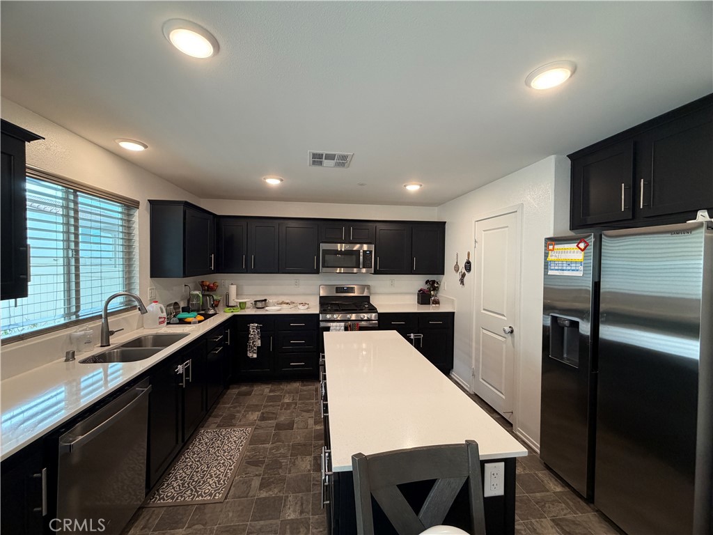 1316 Goldenbrush Way Banning, CA 92220 - Photo 5 of 17 a kitchen with stainless steel appliances a sink stove and refrigerator