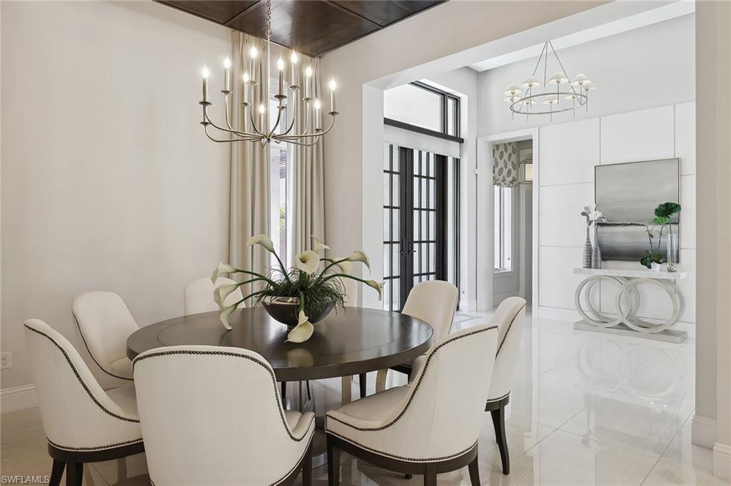 675 Anchor Rode Drive Naples, FL 34103 - Photo 5 of 19 a view of a dining room with furniture and chandelier