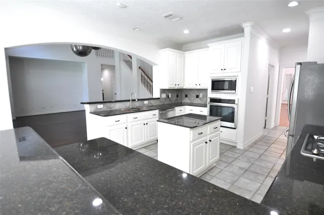 a kitchen with a sink stove and refrigerator